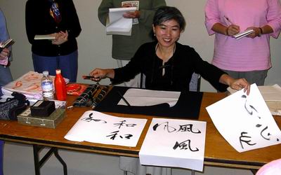 Noriko Maeda shows three words to practice: harmony, wind and spirit