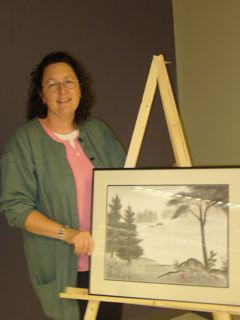 Deborah Johnston beside her graduation painting