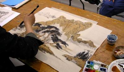 Mountains are coloured by a large brush with lots of water to lessen tone