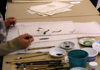 Crane feathers and bamboo emerge on painting