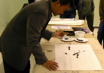 William Ho studies pattern of picture with fish