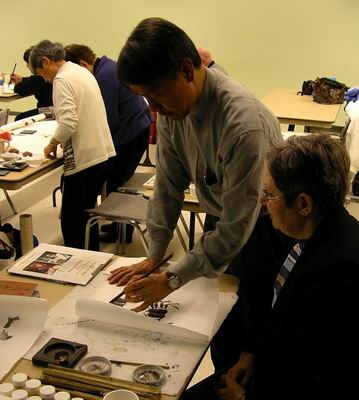 Helping participant with painting of crab
